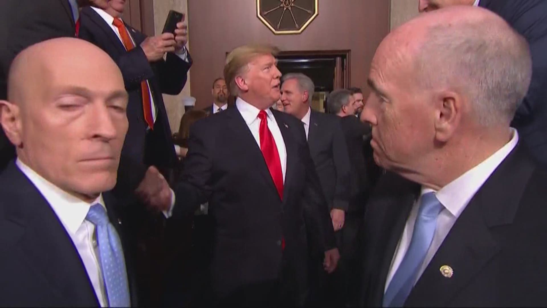 President Trump greets guests and politicians as he arrives for the 2019 State of the Union