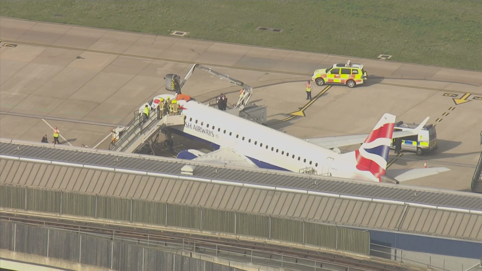 A climate change activist, later identified as a Paralympic cyclist, was detained by police on Thursday after climbing on top of a British Airways plane. (AP)