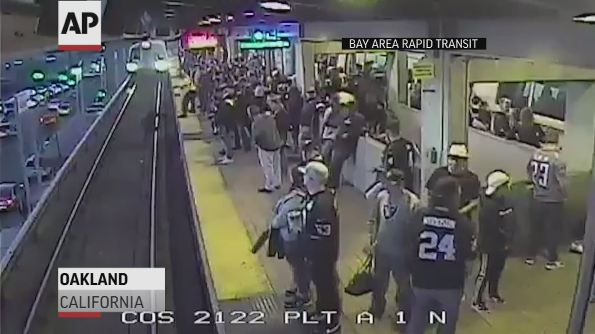 A transit supervisor is being hailed as a hero after pulling a man off train tracks when he fell from a crowded platform following an Oakland Raiders football game.
