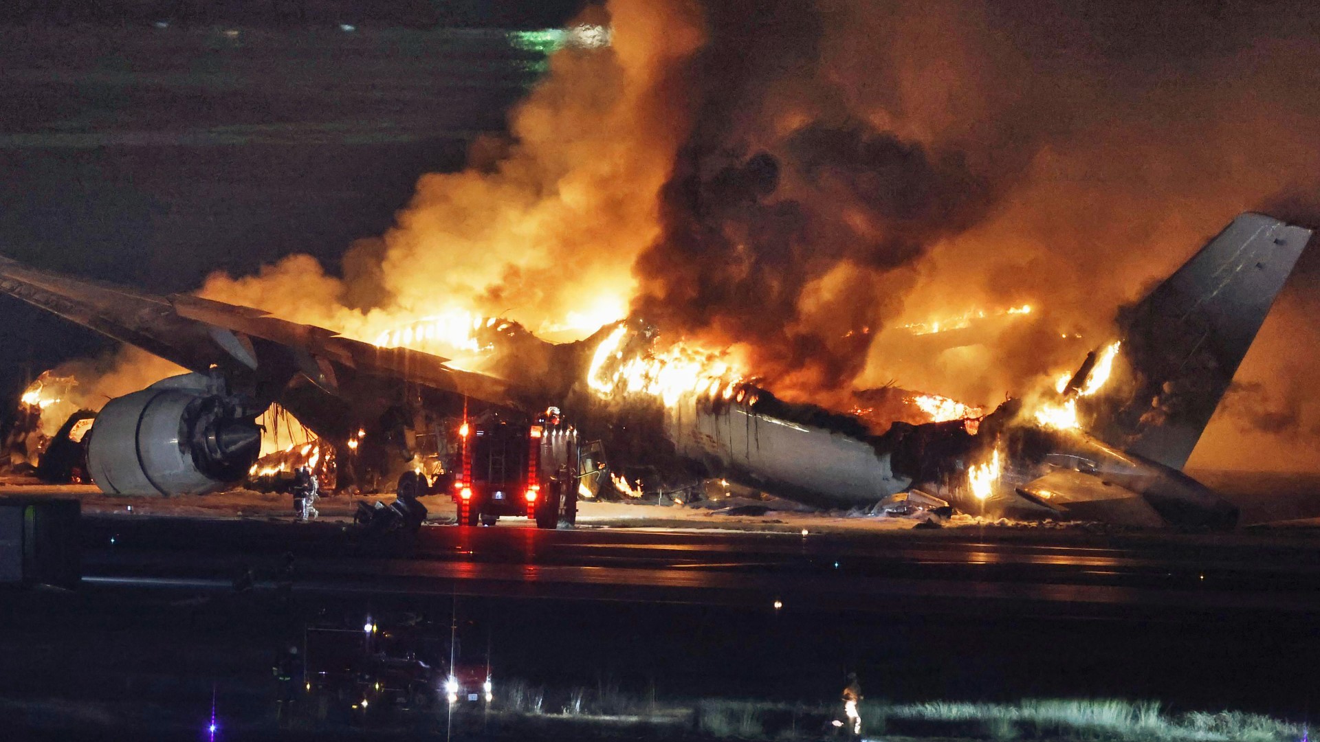 A plane burst into flames on the runway of Tokyo’s Haneda airport on Tuesday, with news reports saying it hit another aircraft after landing.