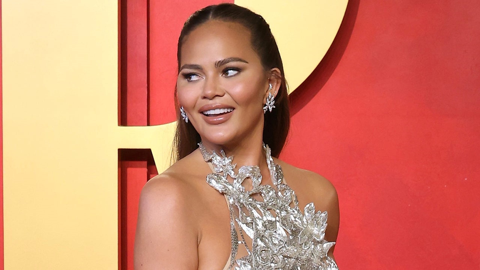 Chrissy Teigen Shows Off Her Boob Lift Scars In Sheer Dress