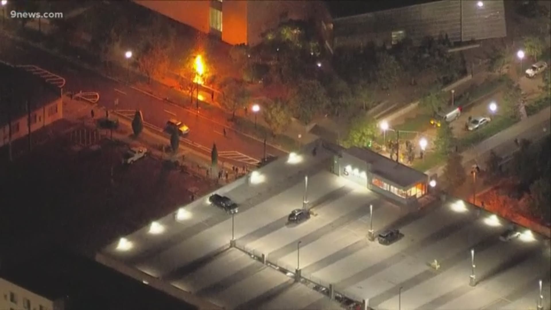 Demonstrators gathered outside Denver Police Department headquarters before setting fires, breaking windows and throwing fireworks on Saturday, Aug. 22, 2020.