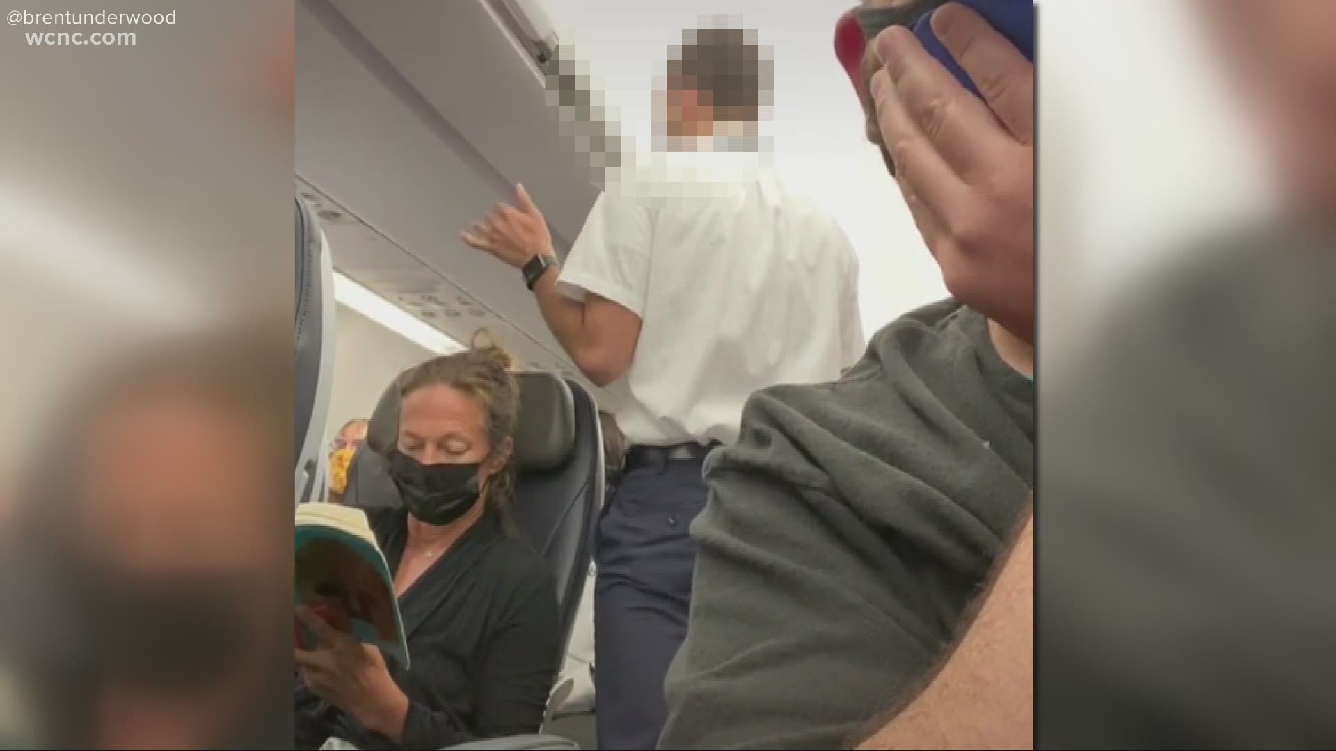 One video shows the lead flight attendant saying he won't tolerate disrespect by passengers for the crew. The flight was diverted to Raleigh due to weather.