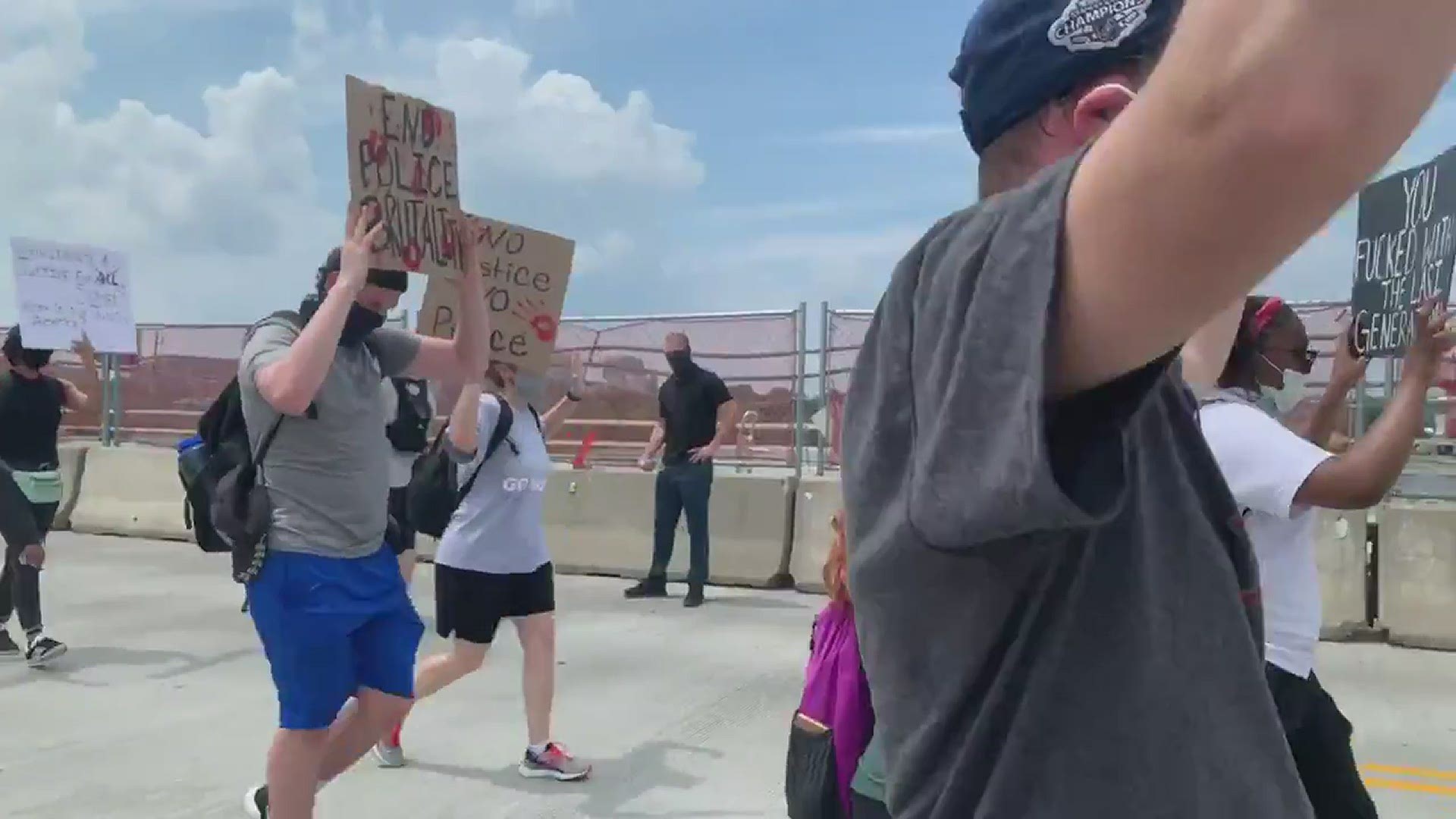 Demonstrators march across the Arlington Memorial Bridge protesting police brutality in wake of the killing of George Floyd in Minneapolis.