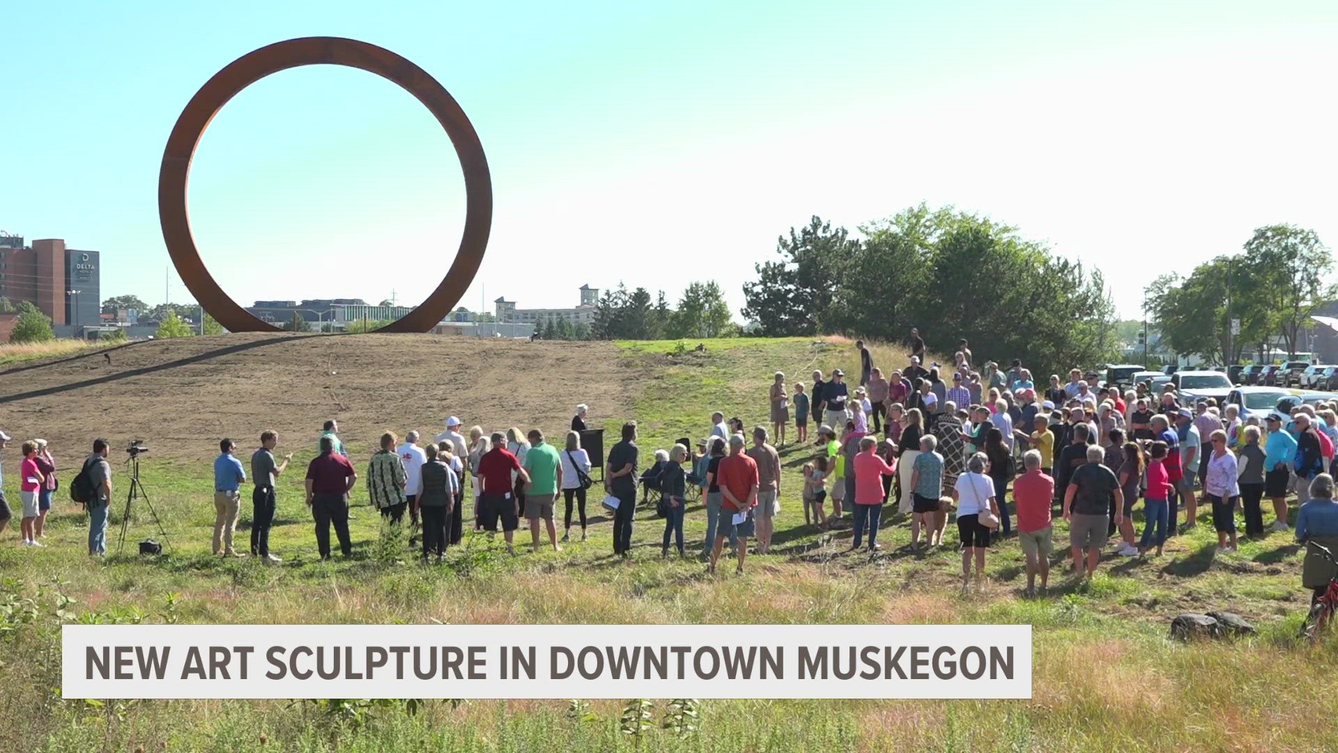 Members of the Muskegon community gathered for the dedication ceremony of a new art sculpture called "The Portal" located downtown.