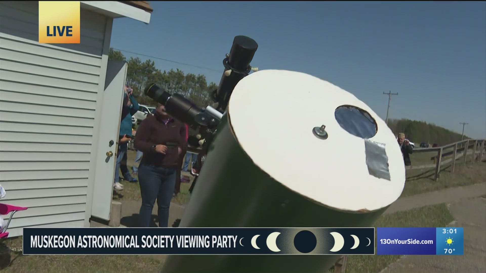 Folks in Muskegon are enjoying the moments before the maximum point of the solar eclipse.