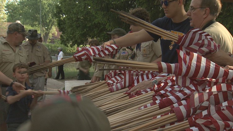 Scouts, volunteers places flags on graves for Memorial Day