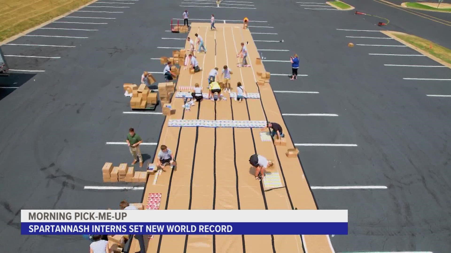 The interns used 5,791 items to spell out "SpartanNash" in the parking lot of the Grand Rapids headquarters. The food was then donated to a nonprofit.