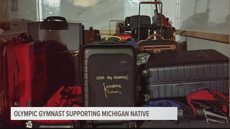 Simone Biles signs suitcases for Michigan foster children