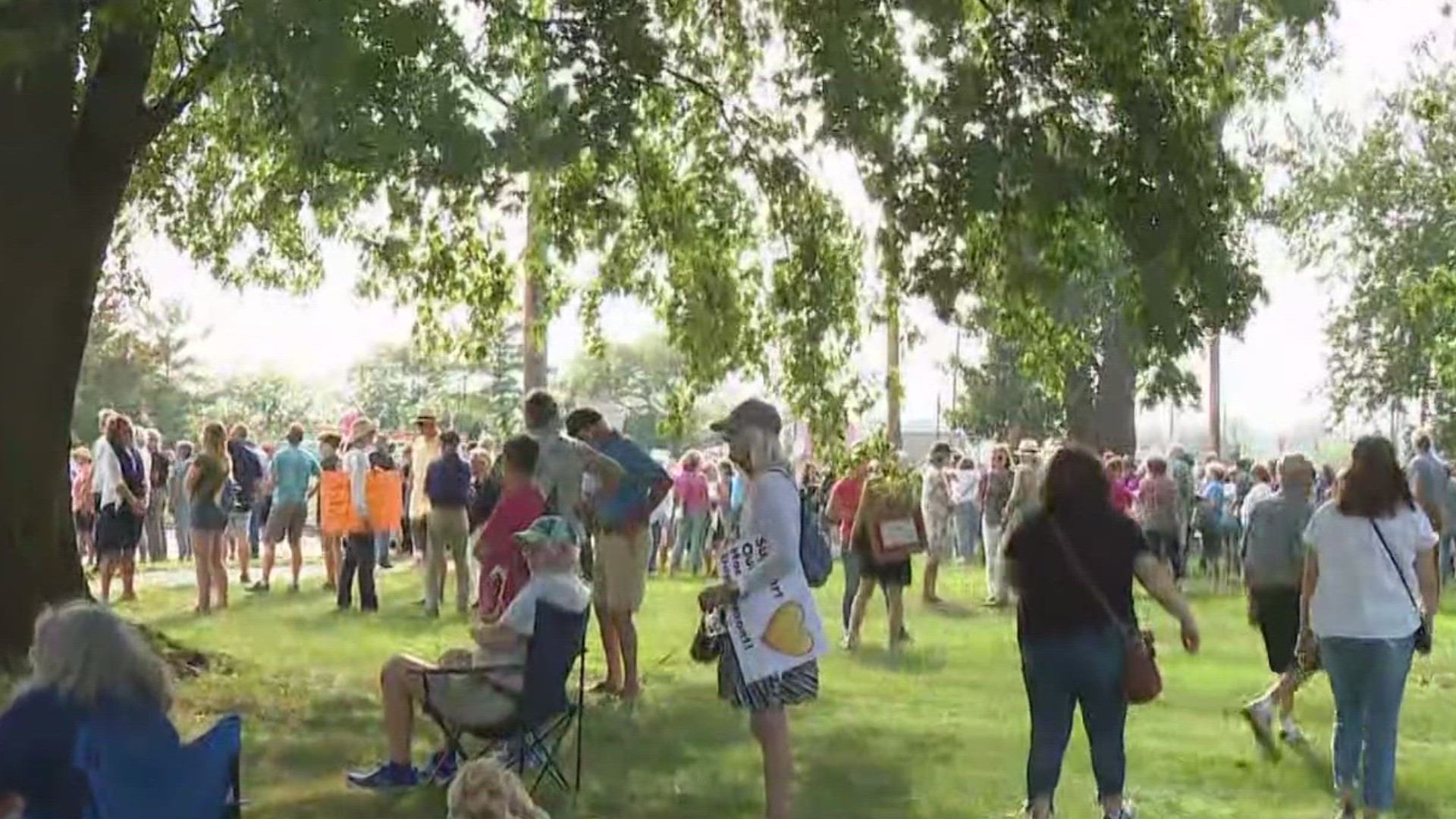 Rallygoers share their support of the Ottawa County Health Department which is facing funding cuts.