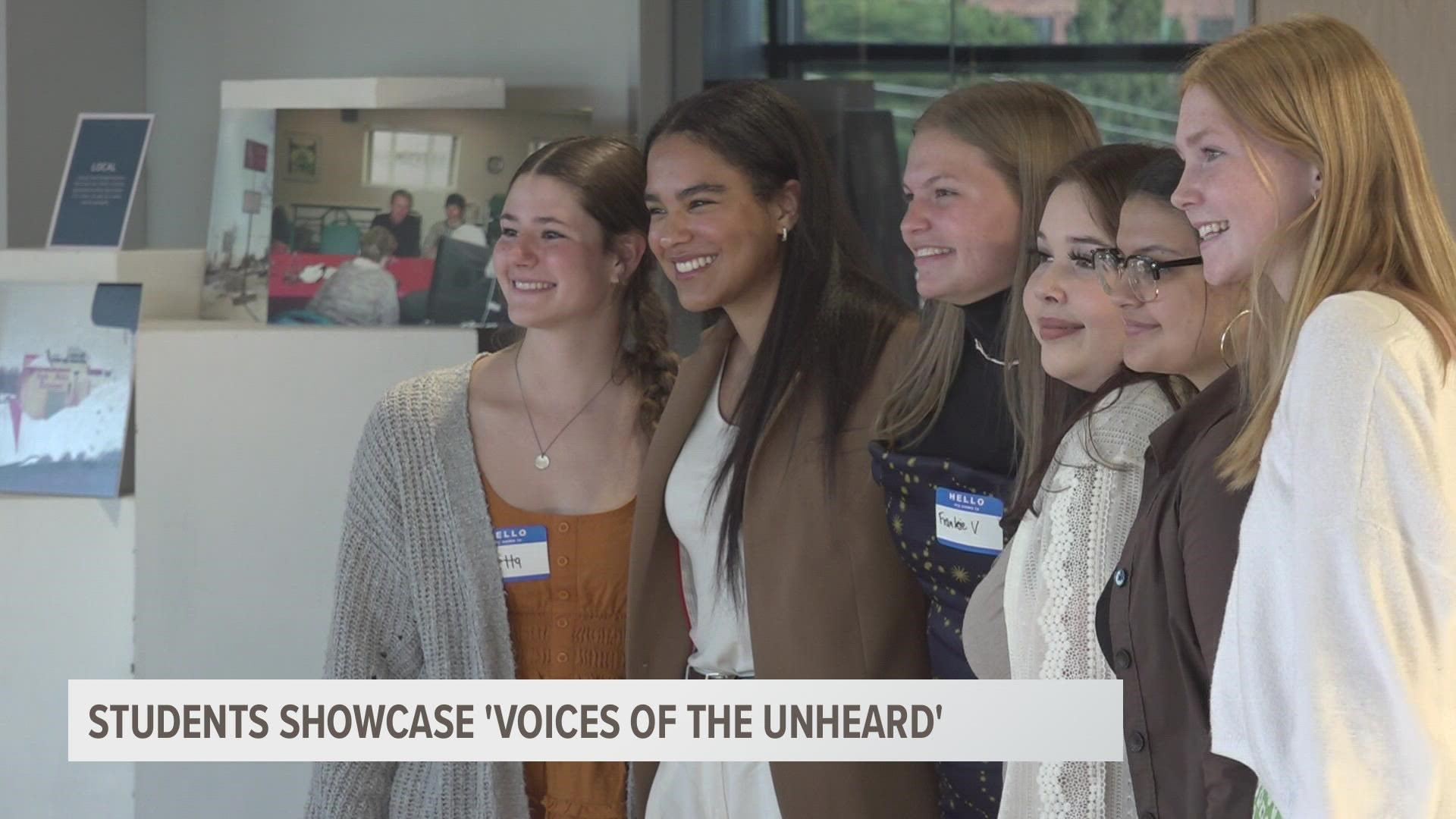 Students from the Young Leaders Against Violence program curated the photo exhibit called "Voices of the Unheard," which went on display Wednesday night.