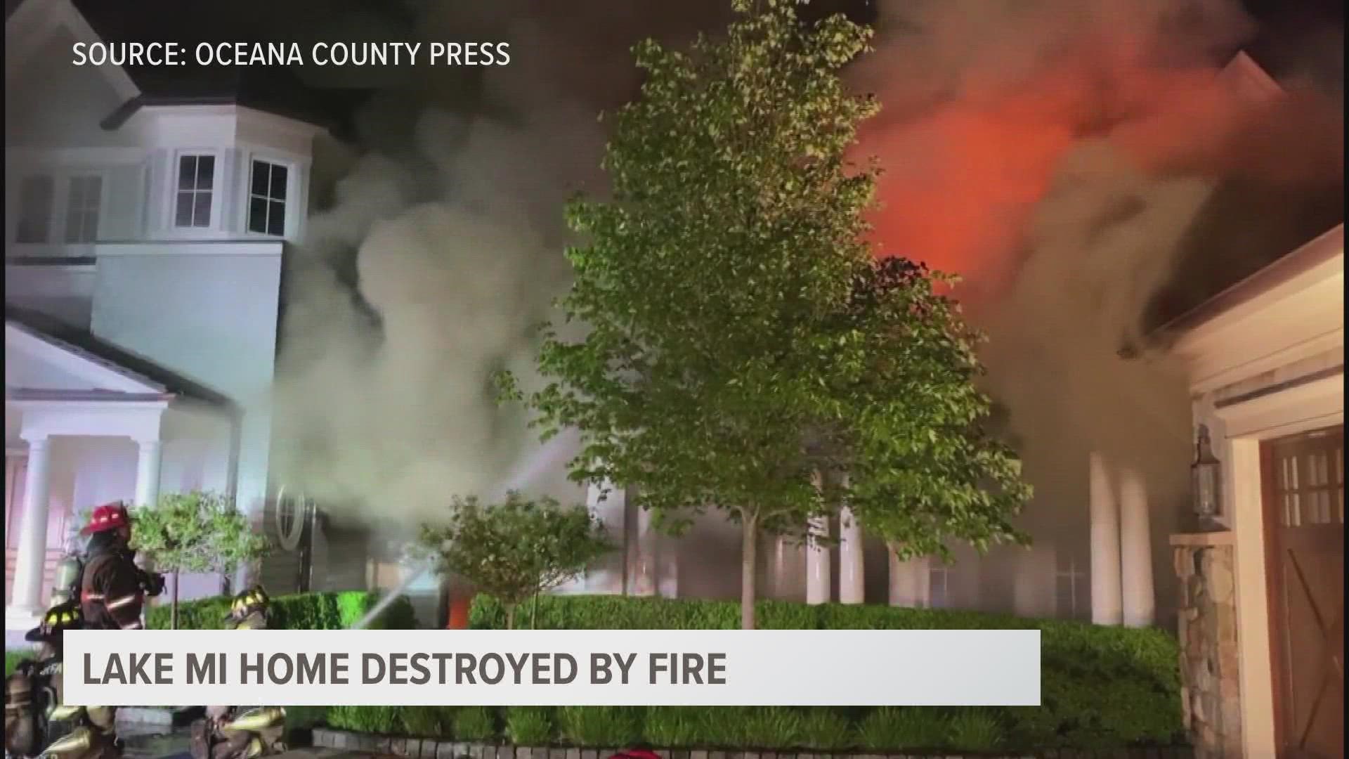 A huge home along Lake Michigan is still smoldering after multiple fire departments responded to a call of someone smelling smoke.