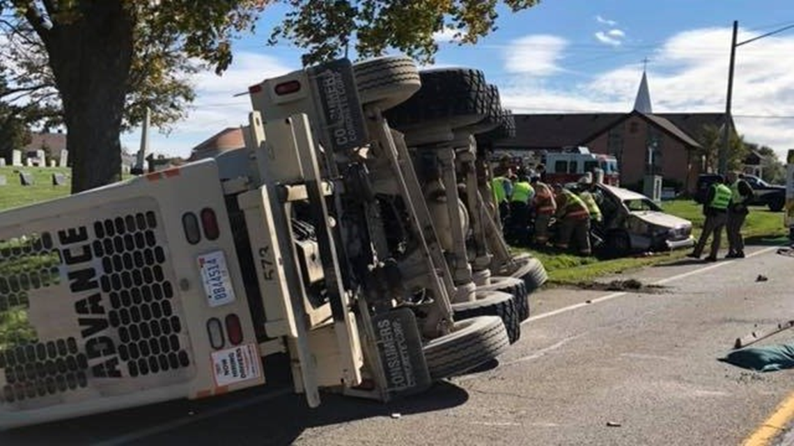 Cement truck overturns in crash with car in Gaines Township