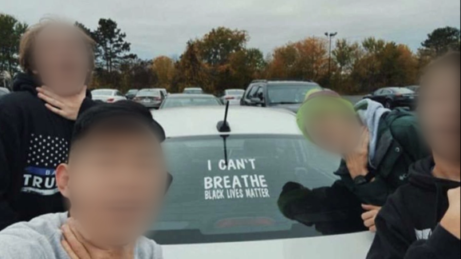 A picture widely shared on social media shows four West Michigan teenagers appearing to mock the death of George Floyd, in front of a Black Lives Matter decal.