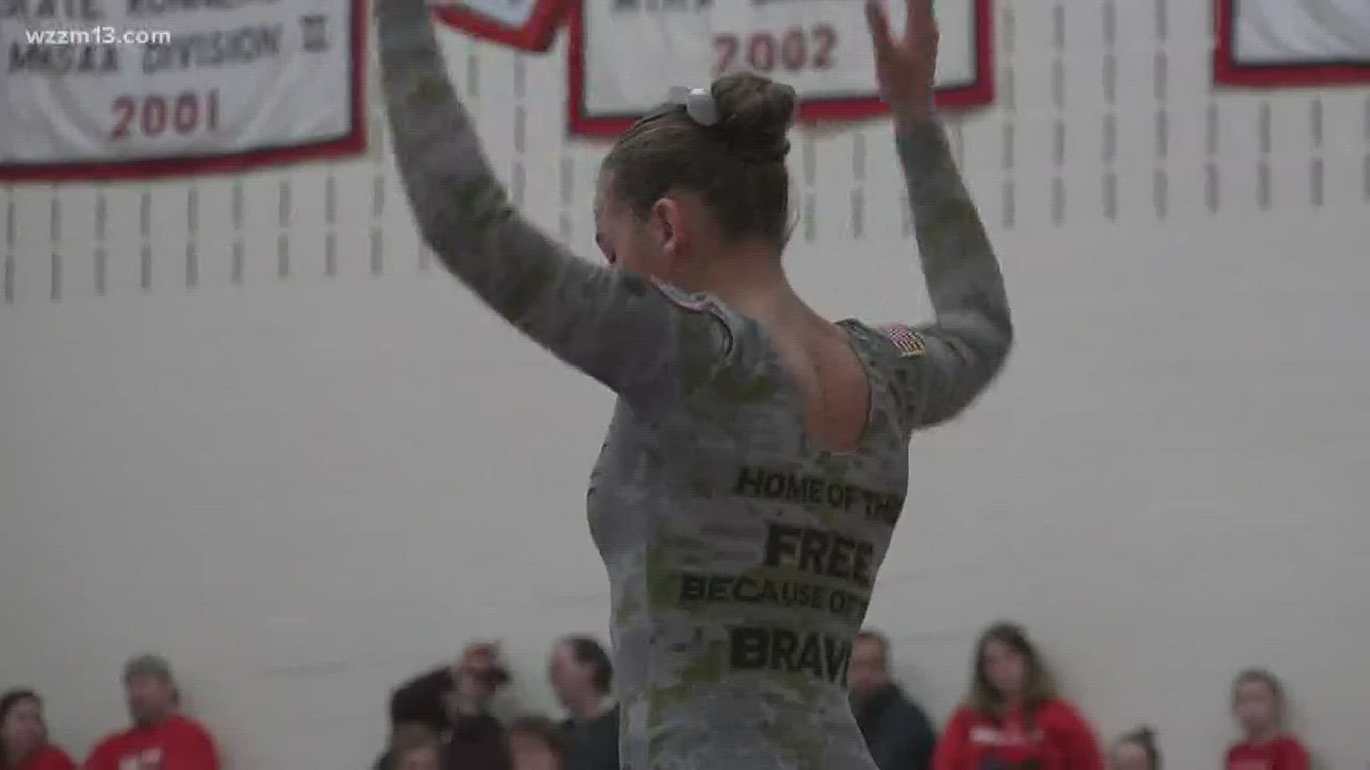 Lowell Gymnastics team honors military at annual tribute meet