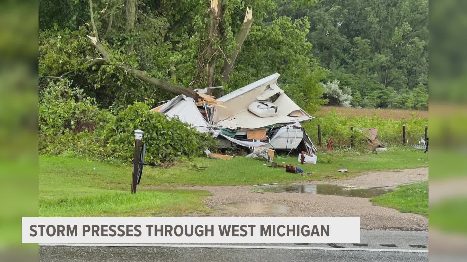 Multiple power outages and damages rocked West Michigan throughout the afternoon, including a tree fall on and crushing a camper.