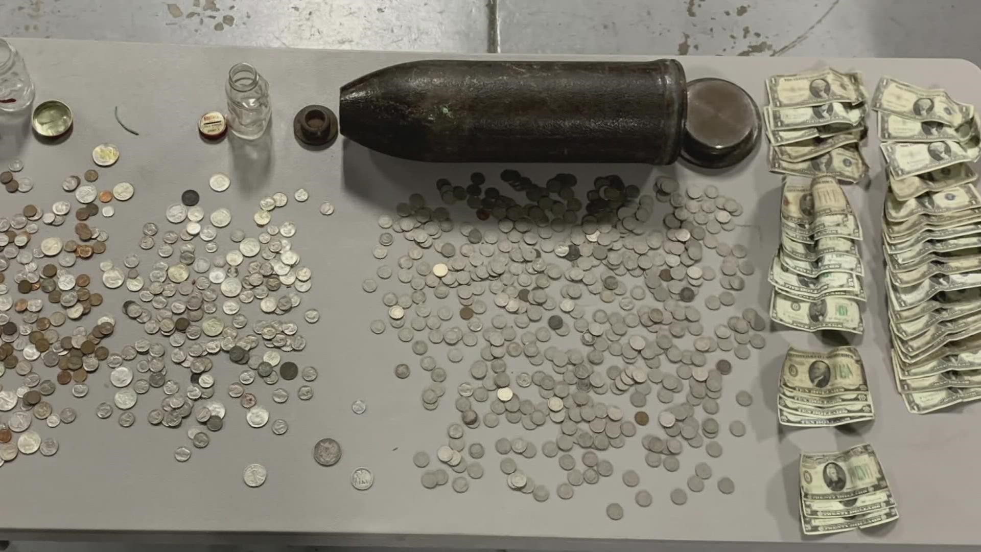 While cleaning out a Lansing home, Melody Atwood was 'shell-shocked' to find a WWI torpedo in the bedroom closet. Inside the round was a massive coin collection.
