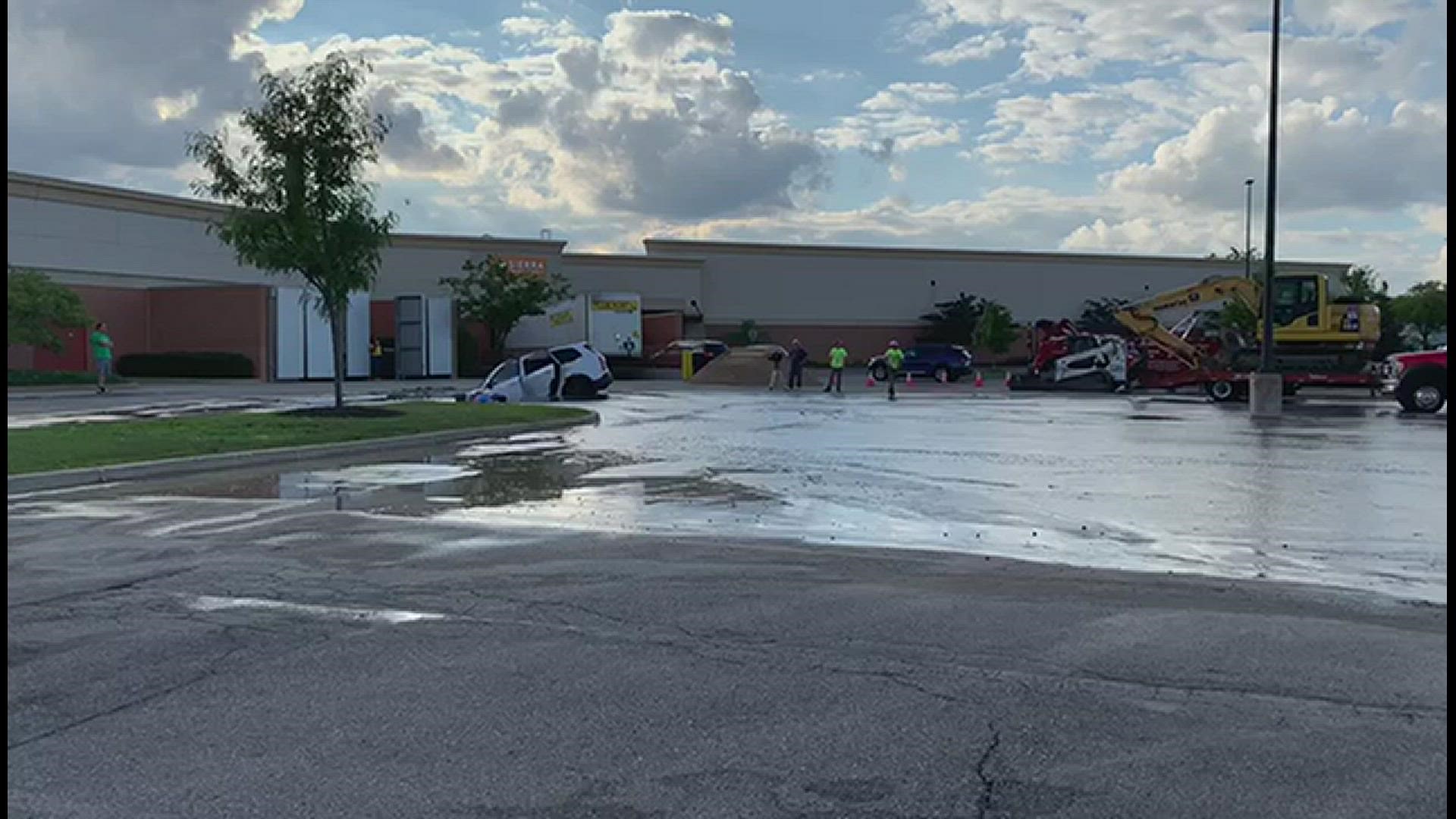 A viewer captured crews working to retrieve a car that went into a hole in Grand Rapids.