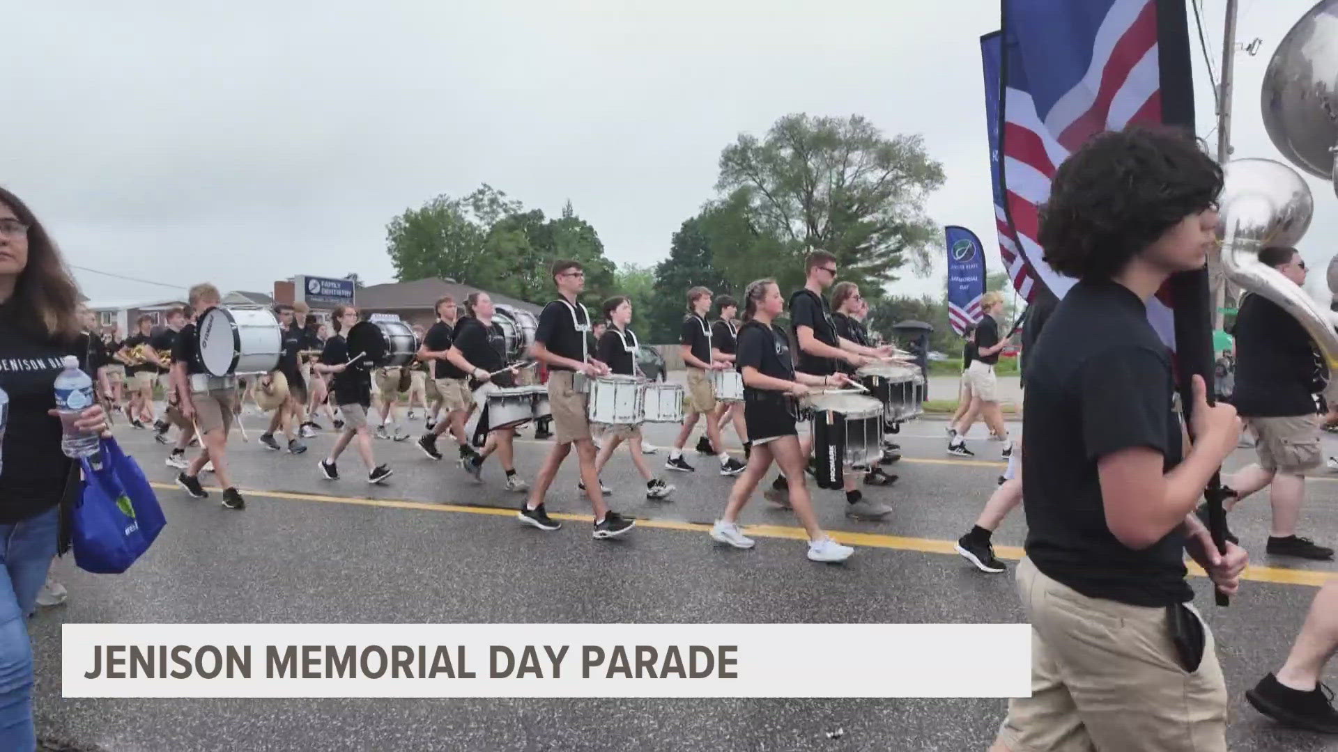 The street was filled with families, flags and pets cheering on a parade filled with fire trucks, a marching band and local veterans in uniform.