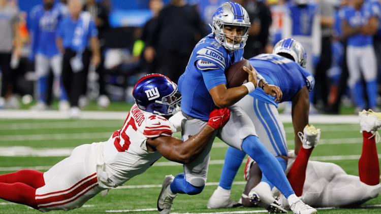 Detroit Lions quarterback Adrian Martinez (18) keeps the ball