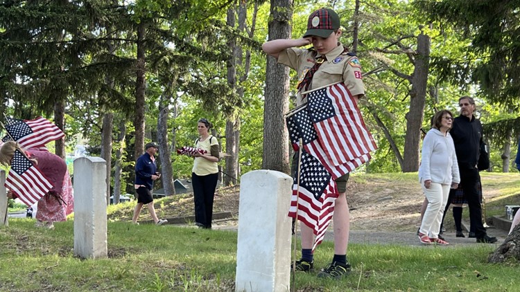 Scouts, volunteers place flags by veterans' graves ahead of Memorial Day