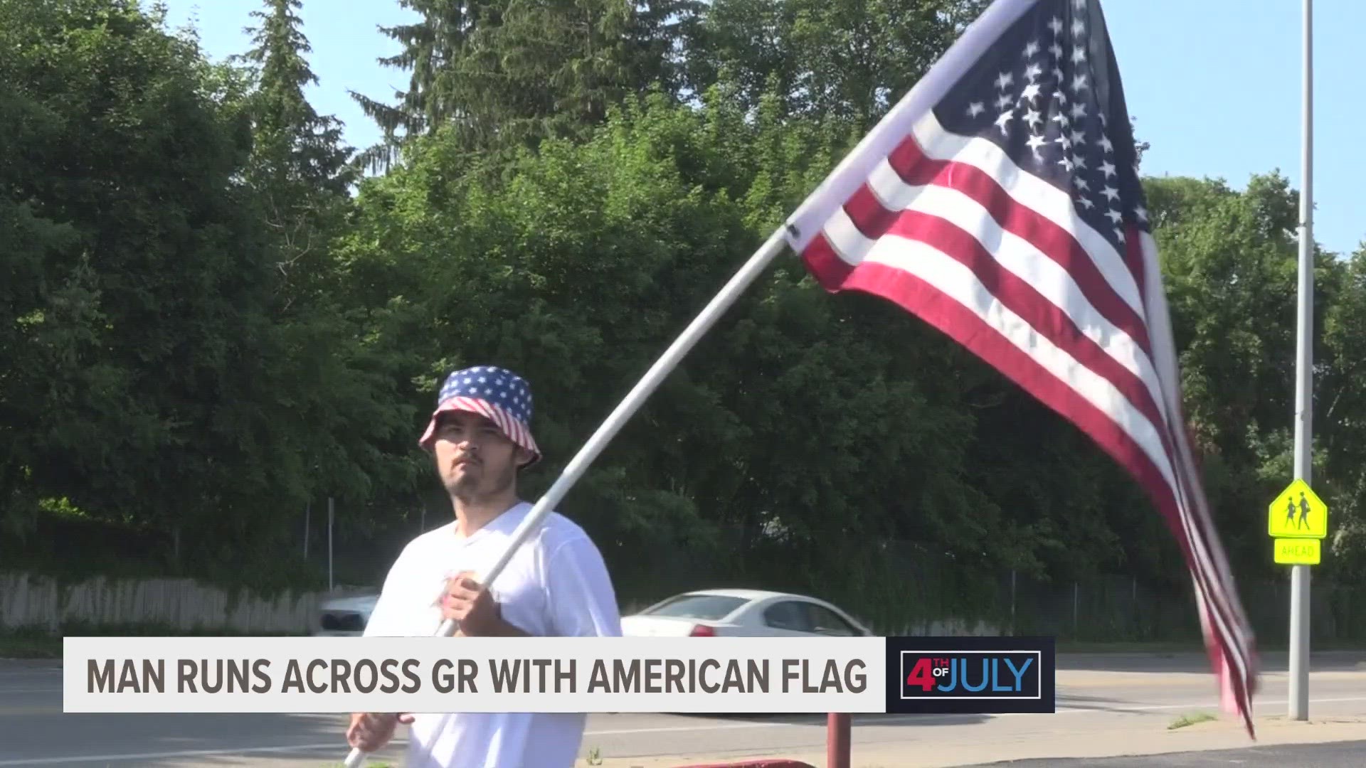 A West Michigan man carried an American flag through Grand Rapids this July 4th to celebrate the holiday one mile at a time.
