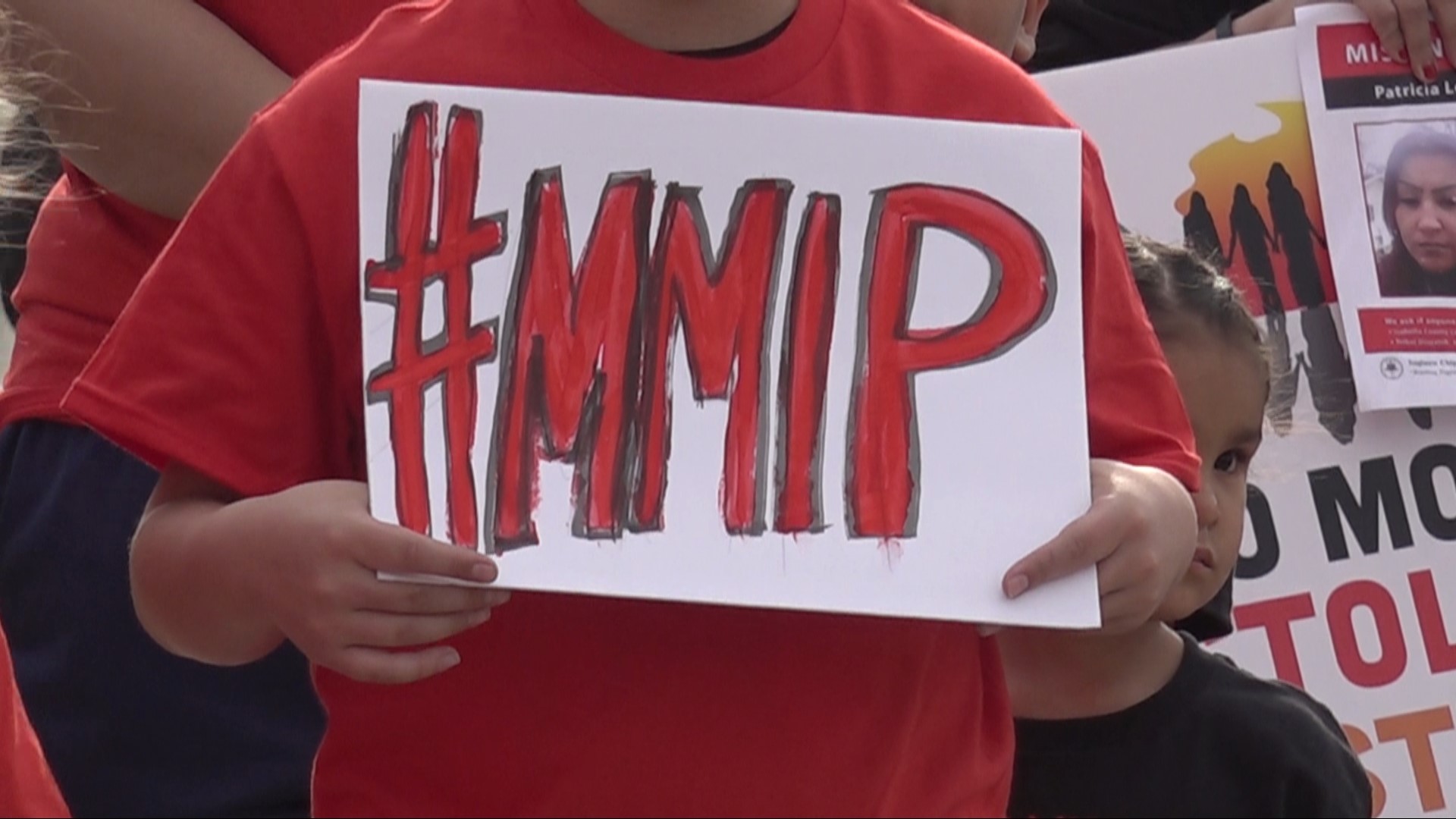 The Blue Bridge turned into a sea of red t-shirts Friday night as dozens of people gathered to call for change.