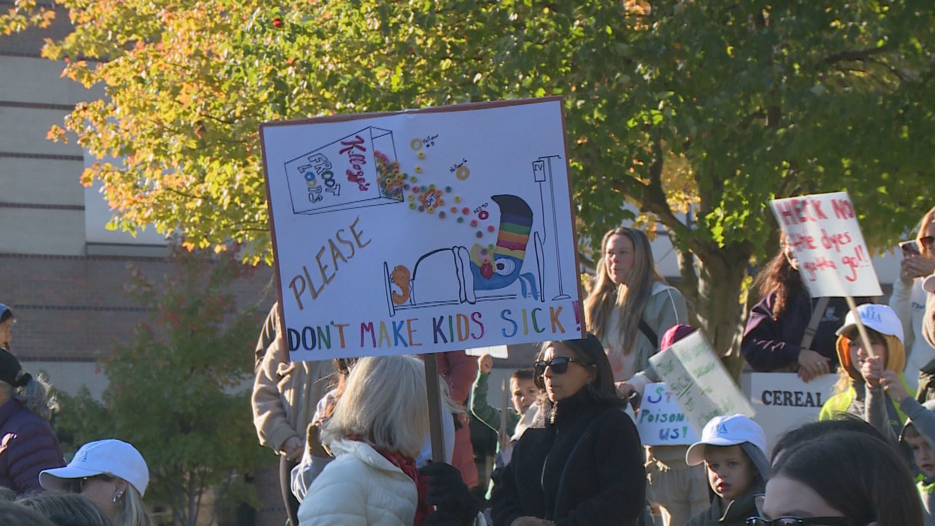 Protestors say the cereal giant continues to use artificial dyes and preservatives in children's cereal, despite a promise to consumers to stop.