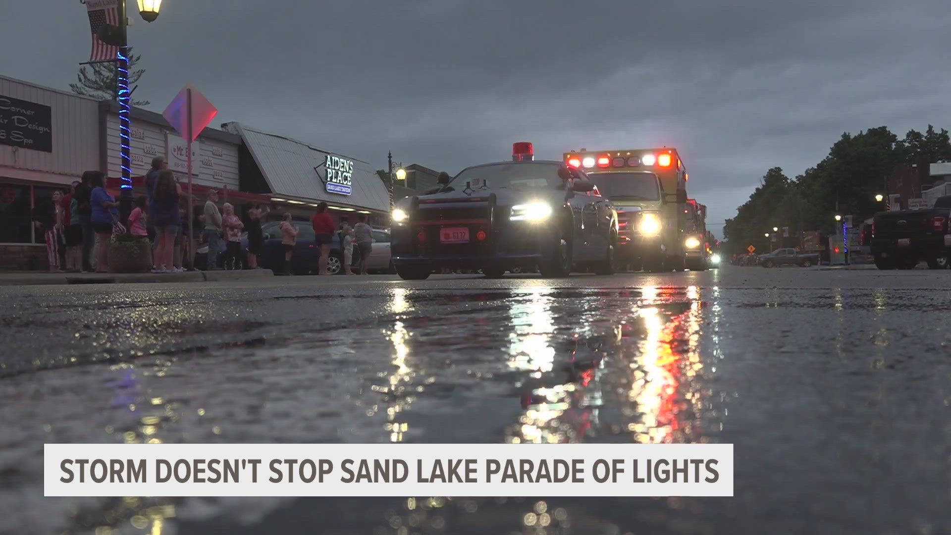 A torrential downpour in Sand Lake left the downtown streets half-flooded tonight. But the people of the village wouldn't let the weather stop them from saluting