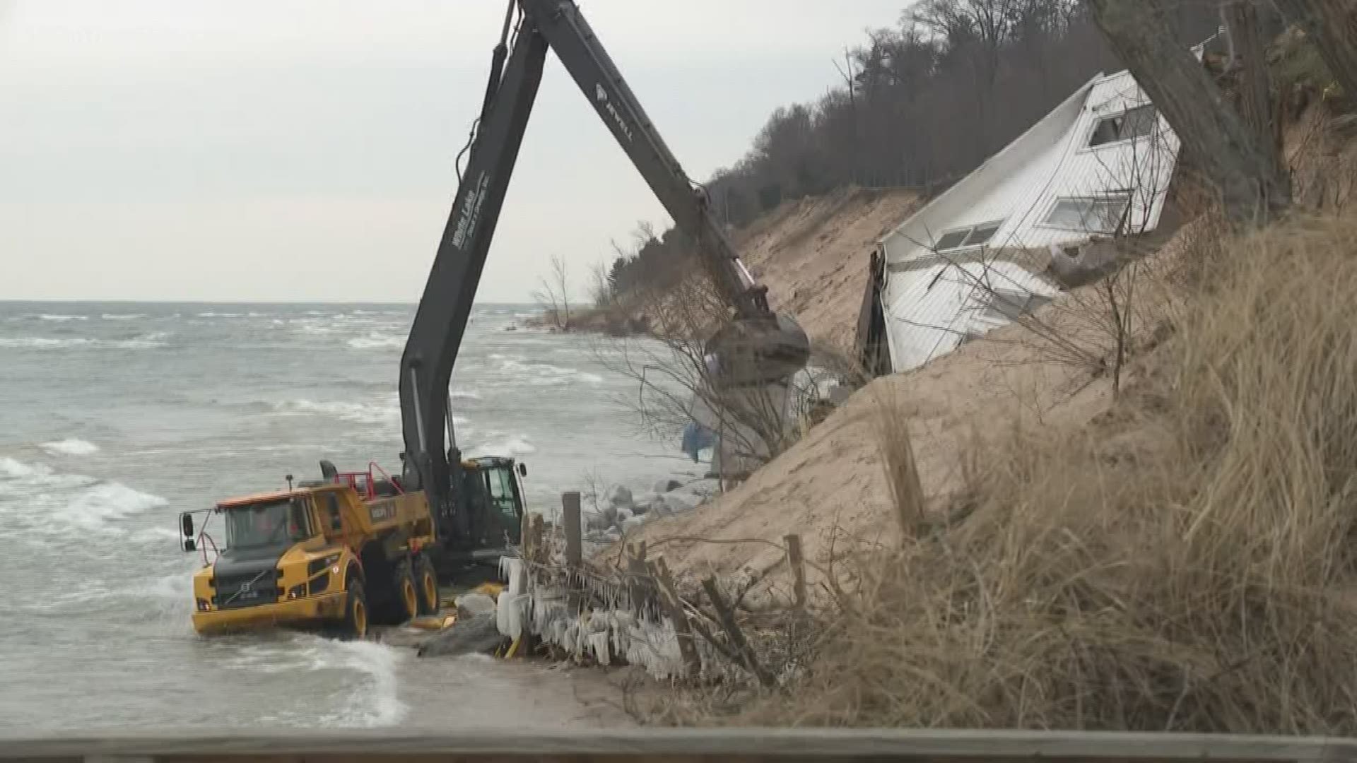 The 100-year-old cottage in Muskegon County's White River Township slipped off its foundation on New Year's Eve and it's been dangling about the water ever since.