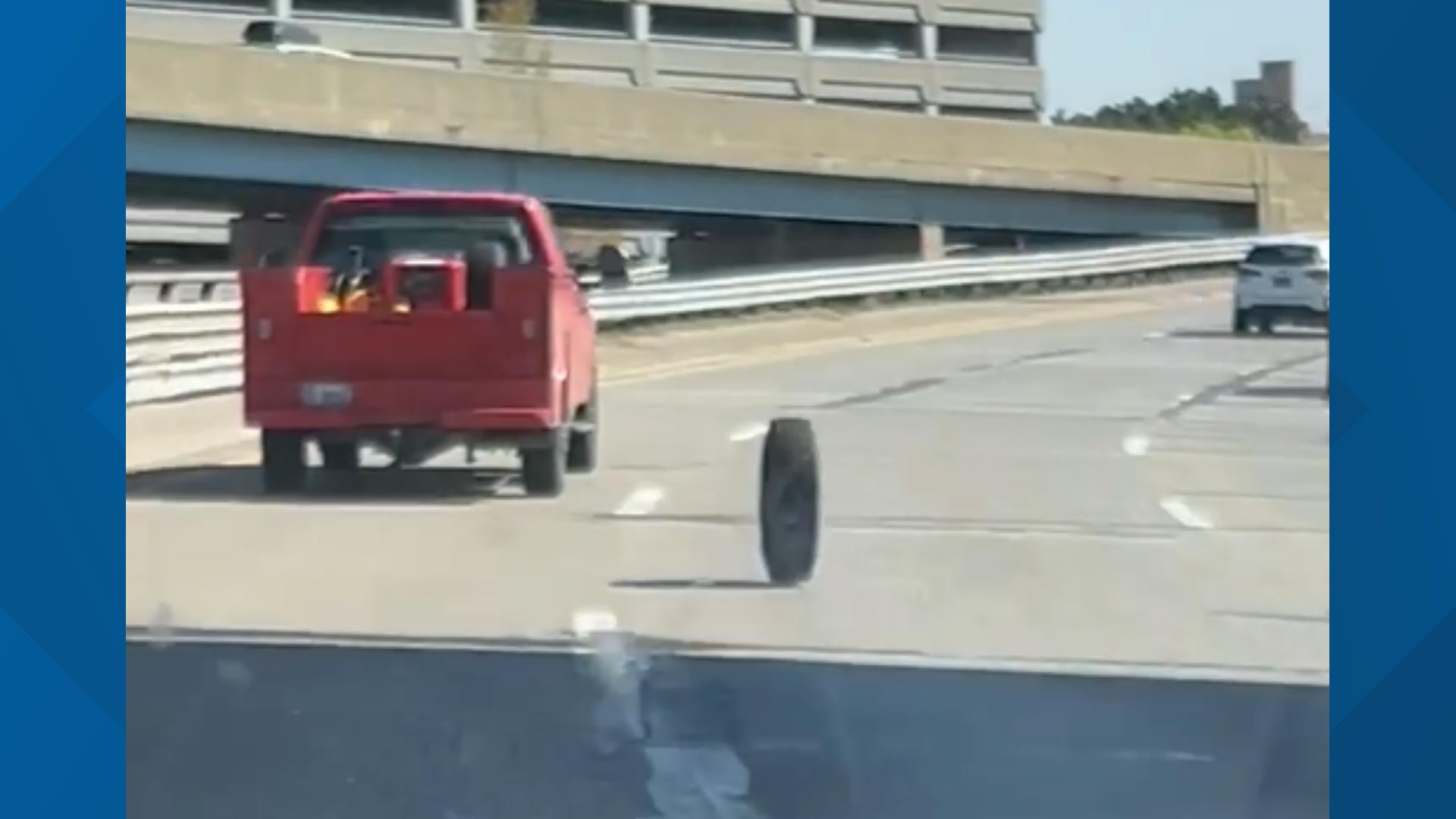 Woman captures video of loose tire on highway