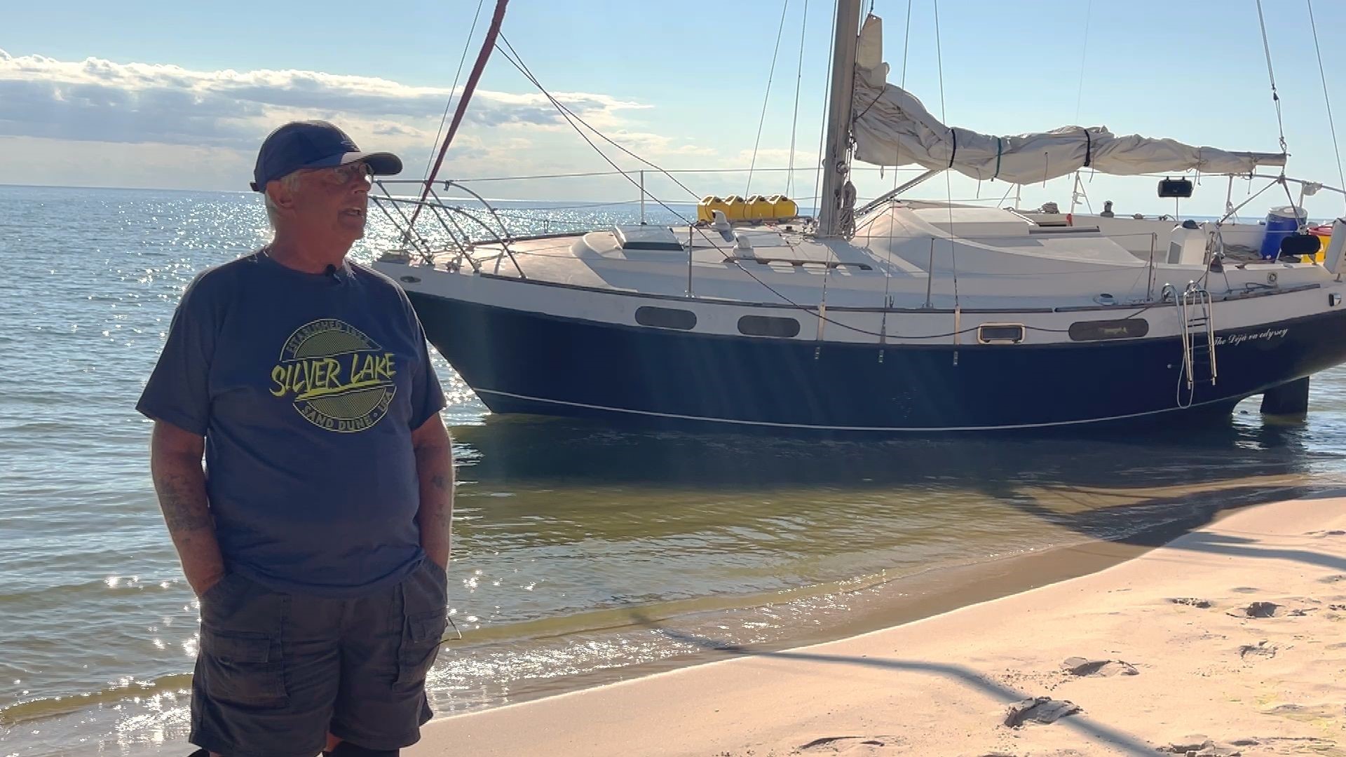 Neighbors try to free stuck sailboat from Lake Michigan shore