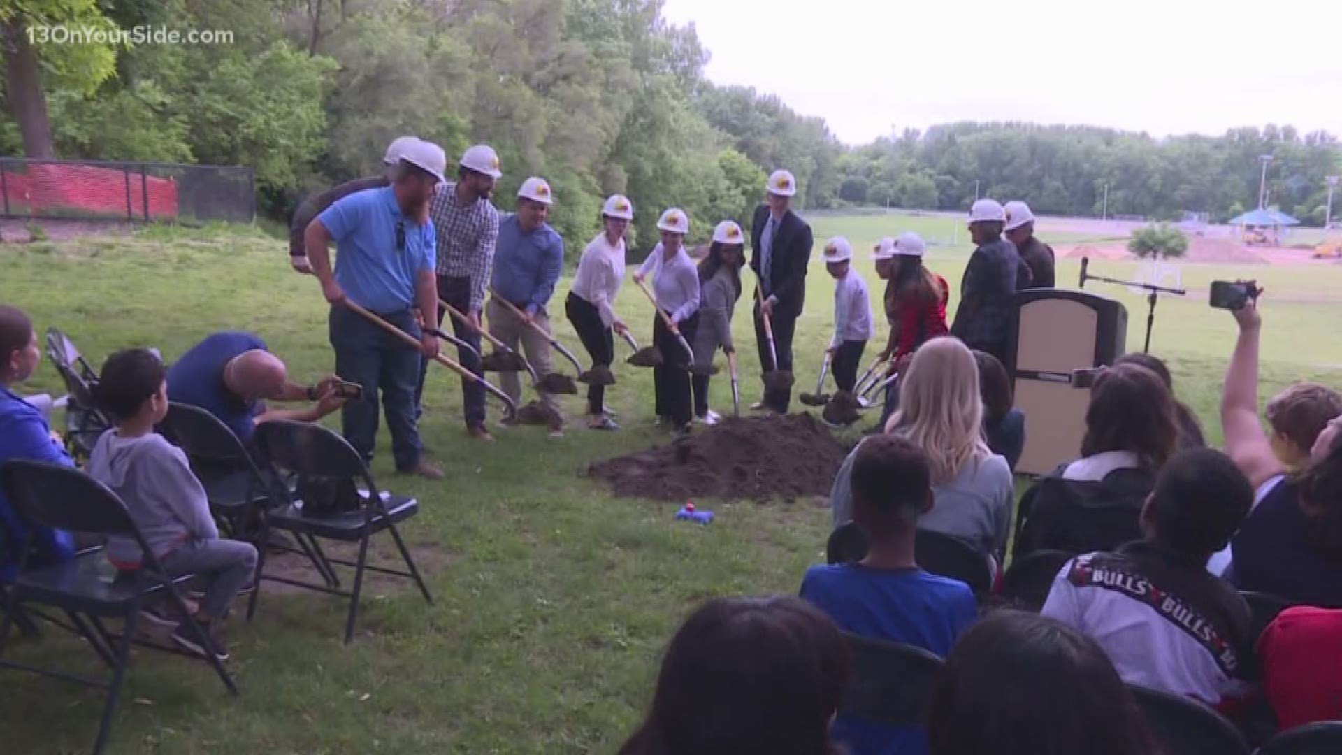City and district officials broke ground on a green schoolyard project at Burton Elementary and Middle School and Plaster Creek Family Park.