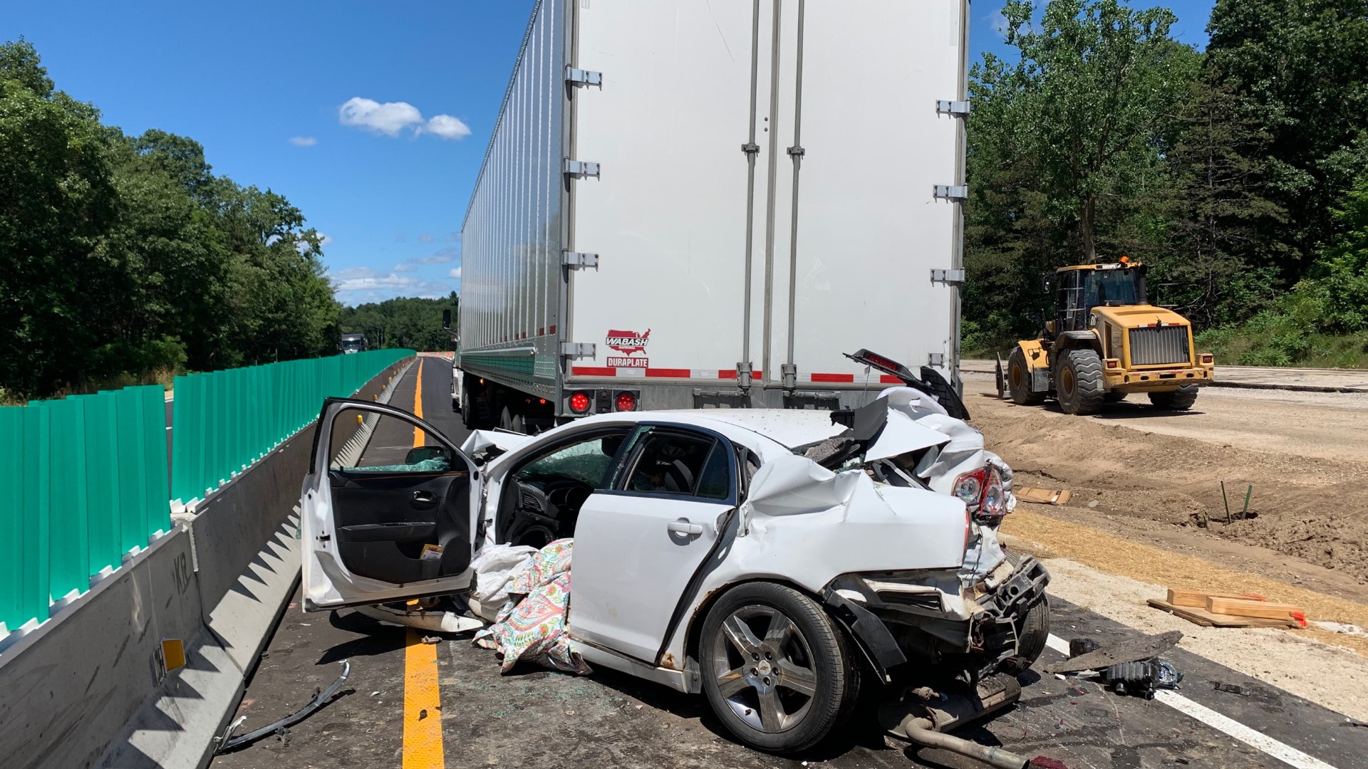Car crashes into back of semi, gets rear-ended on I-96 | wzzm13.com