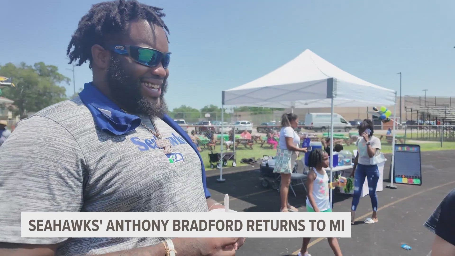 Bradford appeared at Muskegon Heights Academy to sign backpacks for kids, greet the community and more.