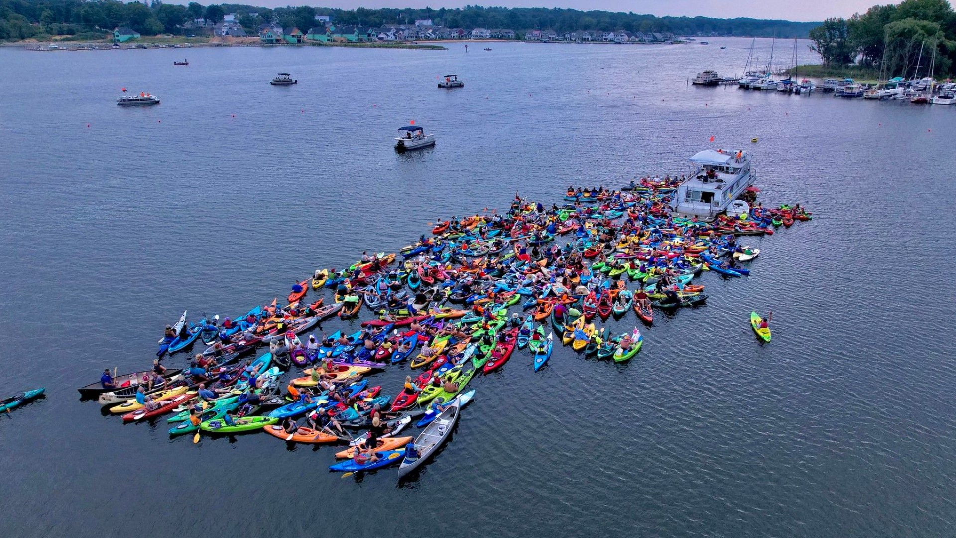 Dozens of kayaks joined together to form a flotilla in White Lake on August 28, Sunday afternoon.